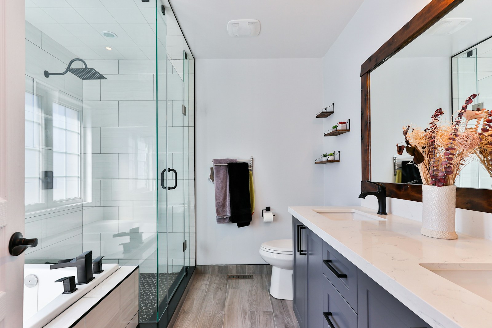 Modern bathroom with updated vanity, fixtures, and glass shower