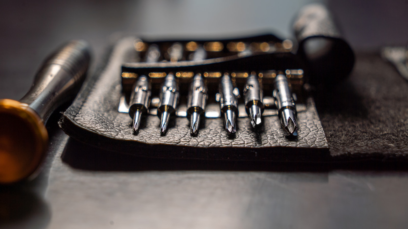 Close-up of precision screwdriver bits arranged for detailed repair work